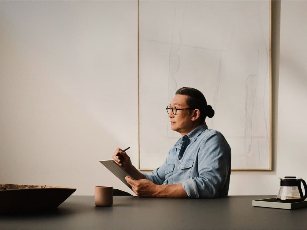 A man reviewing work on a clipboard